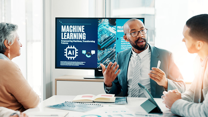 A professional leading an AI training session with colleagues in a conference room.