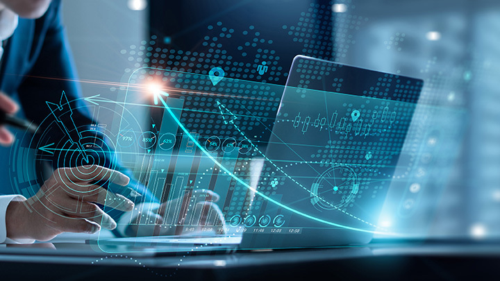 hands working at laptop overlaid with graphics of graphs