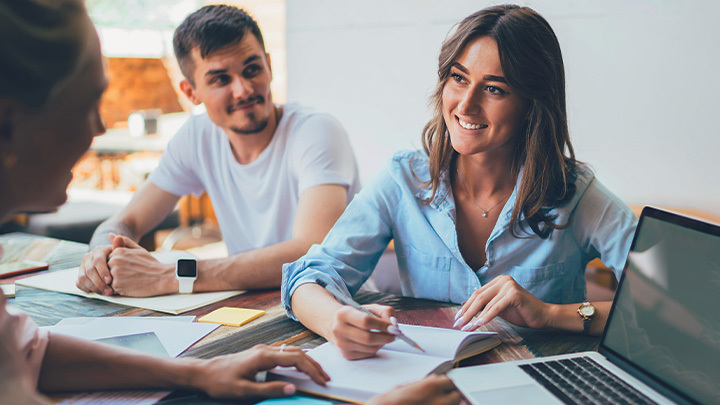 Three people working at table