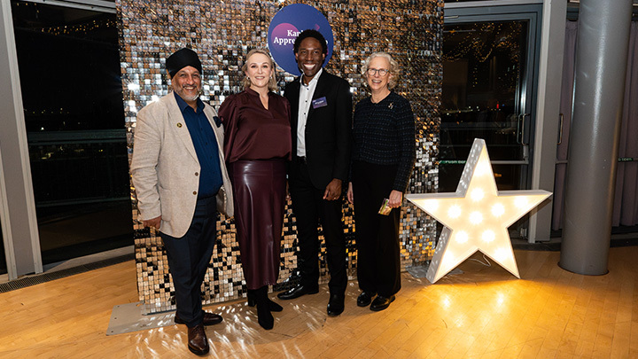 The Kaplan Apprenticeship Awards judges posing in front of the sparkling backdrop and event sign, smiling and dressed in smart attire at the awards ceremony.