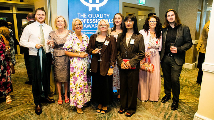 Kaplan compliance team Members of the Kaplan compliance team smiling and posing together with drinks at The Quality Professionals Awards.