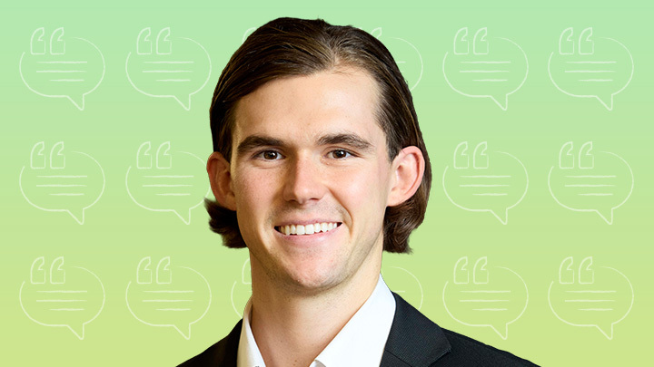 Headshot of Mason Smith smiling in a suit against a light green background with subtle speech bubble patterns.