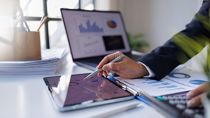 A data and tech apprentice working with data on an electronic tablet