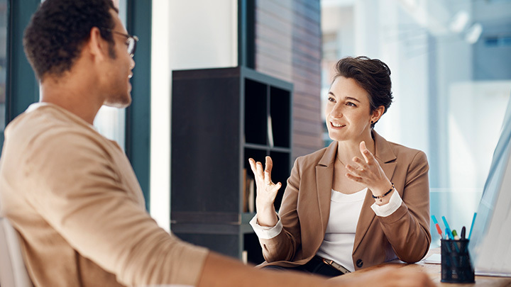 Two people talking at work