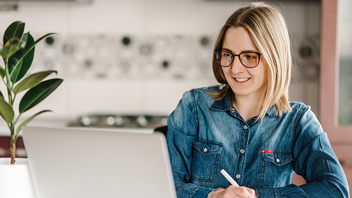 Woman working at laptop, smiling