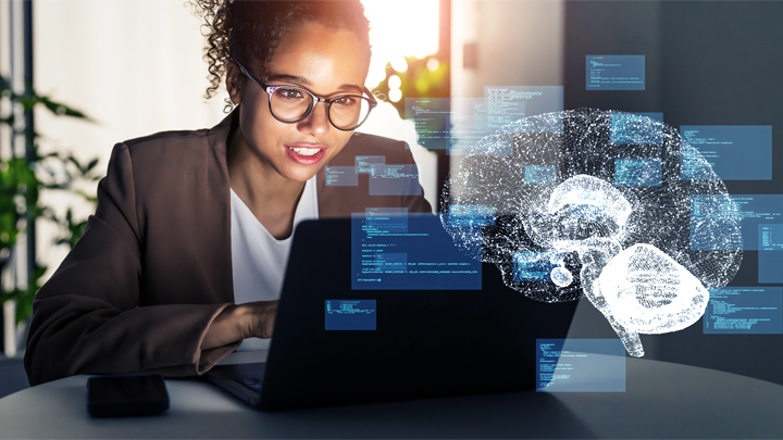 Woman working at laptop with graphic of brain