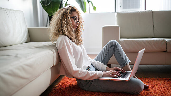 A young woman sitting with her laptop