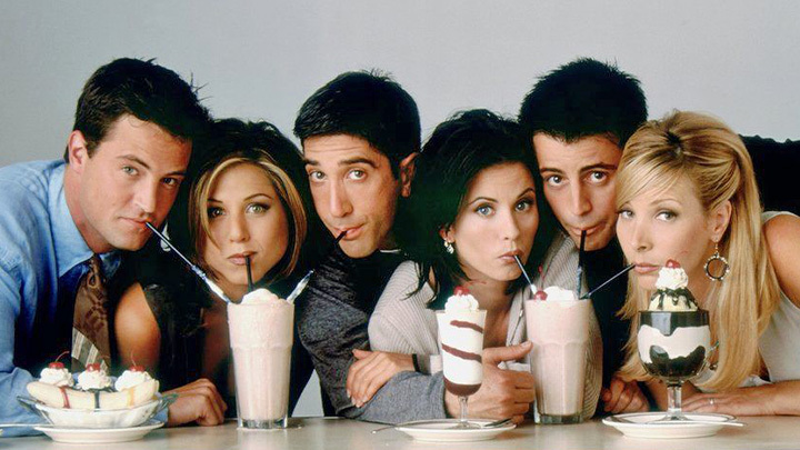 A professional shot of the main six Friends characters drinking milkshakes.
