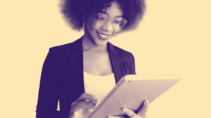 Woman smiling at handheld tablet computer