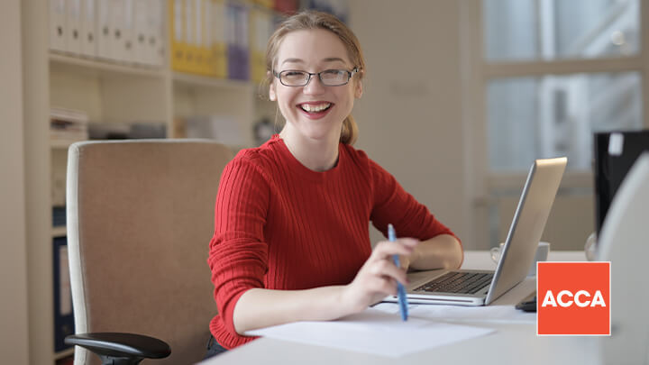 Woman sitting with laptop and smiling