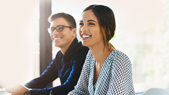 A man and a woman sat down smiling