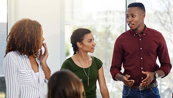 Two women and a man talking