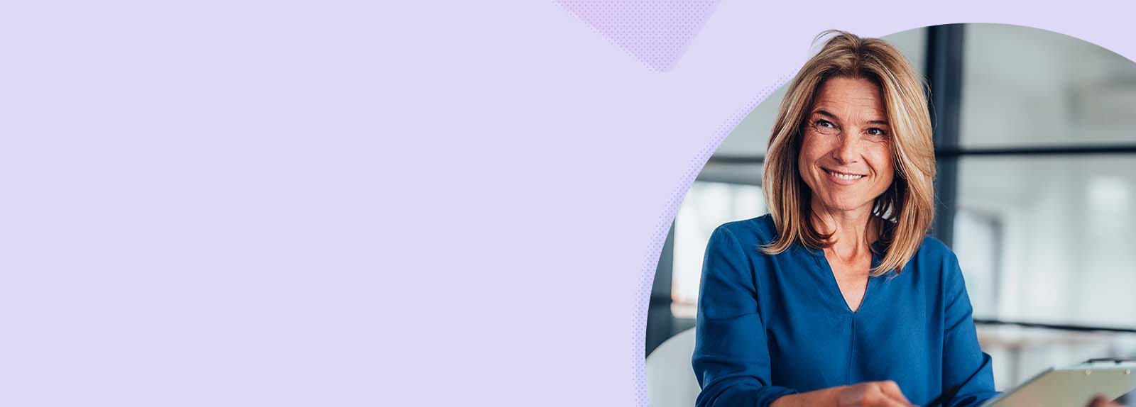 A smiling woman in an office environment.