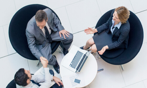 Two men and a woman having a meeting