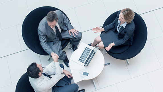 Two men and a woman having a meeting
