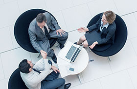 Three people sat down talking