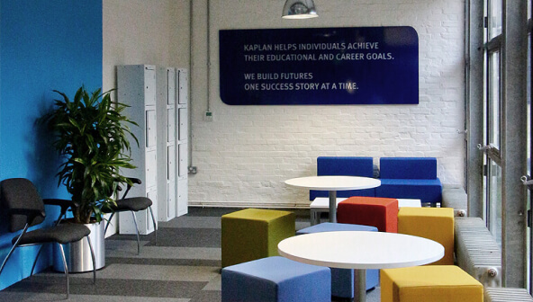 Picture of an office that contains chairs, tables and lockers