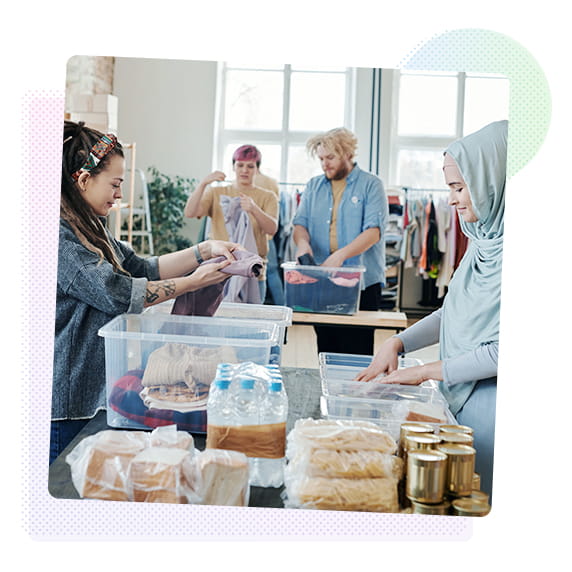 A group of people organising clothes into boxes