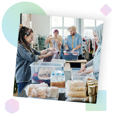 A group of people organising clothes into boxes