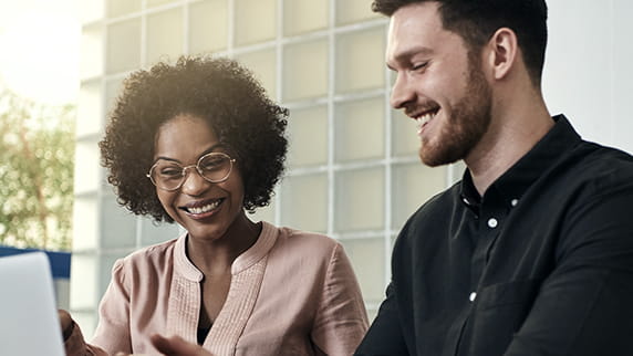 A man and a woman looking at a screen
