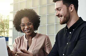 A man and a woman looking at a screen