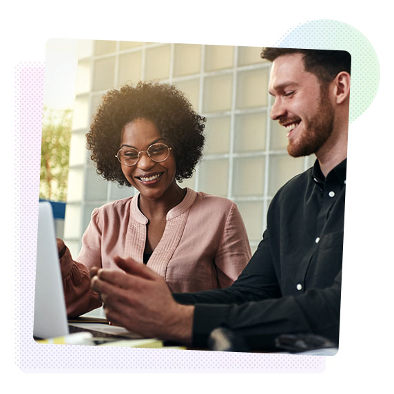 A man and a woman looking at a computer monitor.