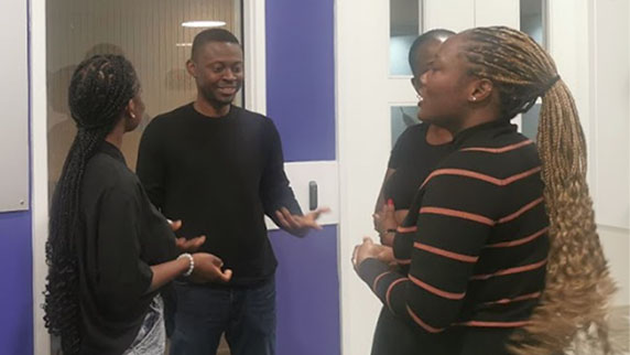 Two black men and two black women talking