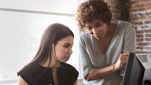 Two women looking at a computer screen