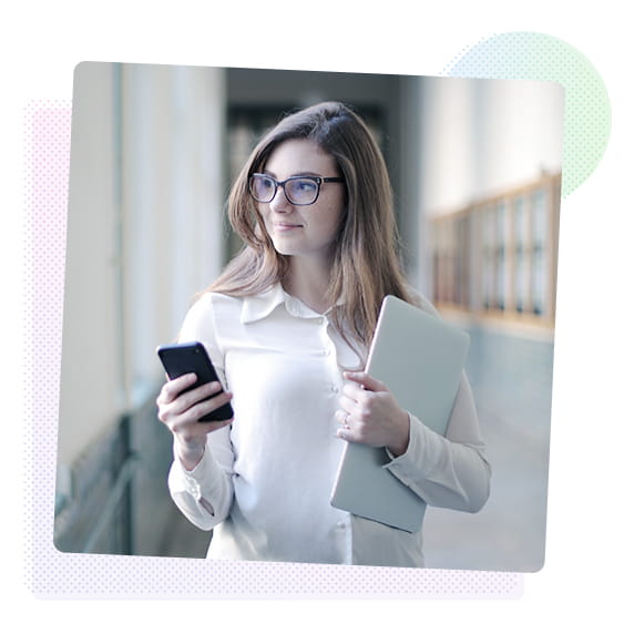Woman holding a phone and a laptop