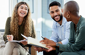 A man and two women sitting and talking