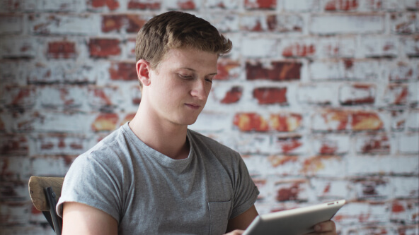 A man looking at a tablet