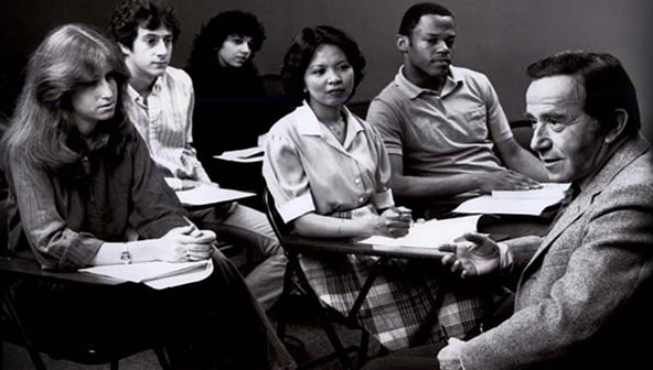 A black and white photo of students and a teacher in a classroom