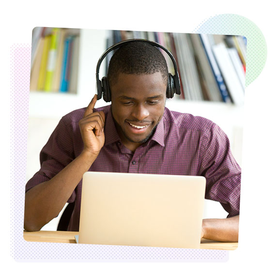 Man wearing headphones  working on a laptop