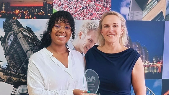 Niamh Clarke, PwC, (left) holding the award for Level 4 - 7 Apprentice of the Year at the Greater Manchester Apprenticeship and Skills Awards 2025. Jenny Pelling, Director of Skills and Strategy, Kaplan (right).