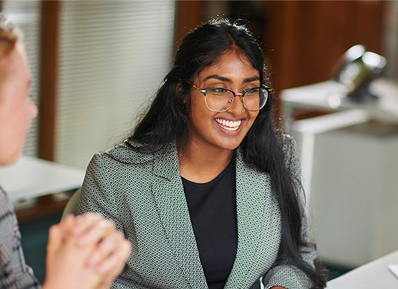 Woman smiles next to a group