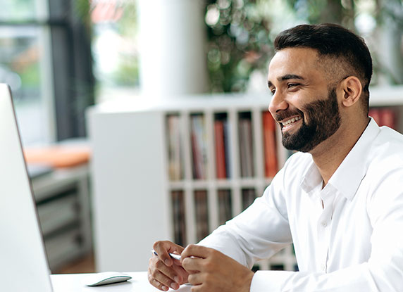 Man smiling at computer