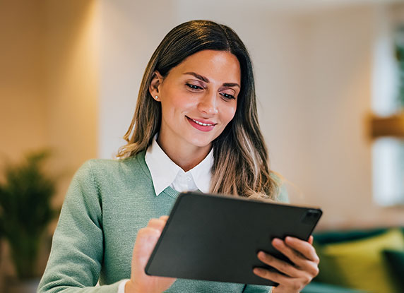 Lady smiles at tablet device