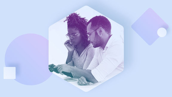 A woman and a man looking at a laptop