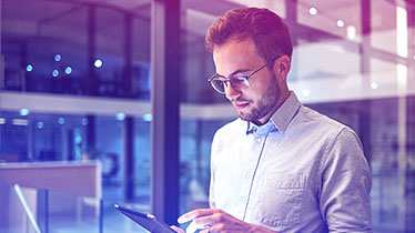 A man looking at a tablet computer