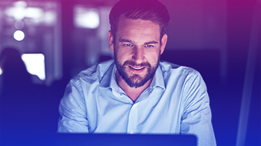 A man looking at a laptop screen.