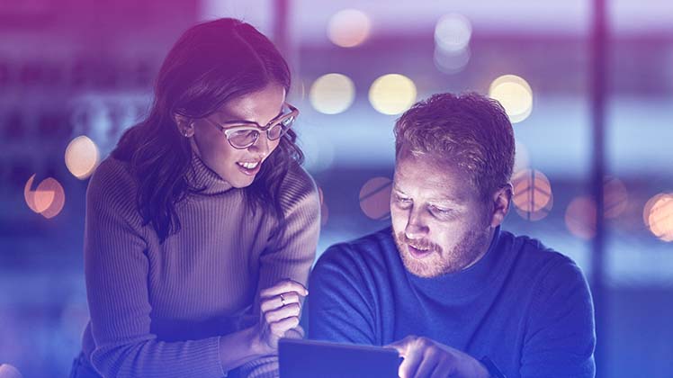 Man and woman looking at a laptop screen