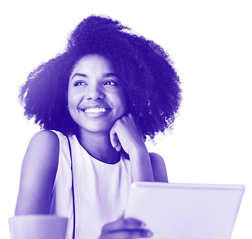 a woman holding a tablet smiling off to the right of her
