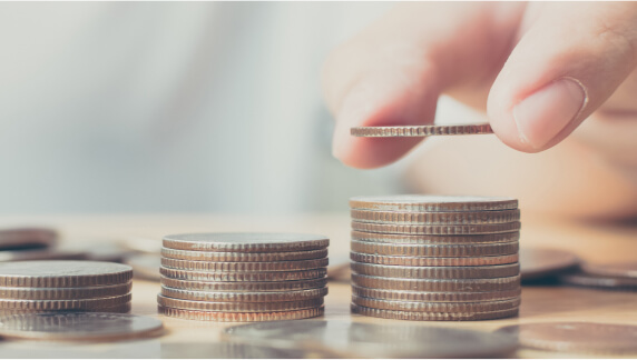 Three piles of coins, each taller than the previous with the final one having a coin addded