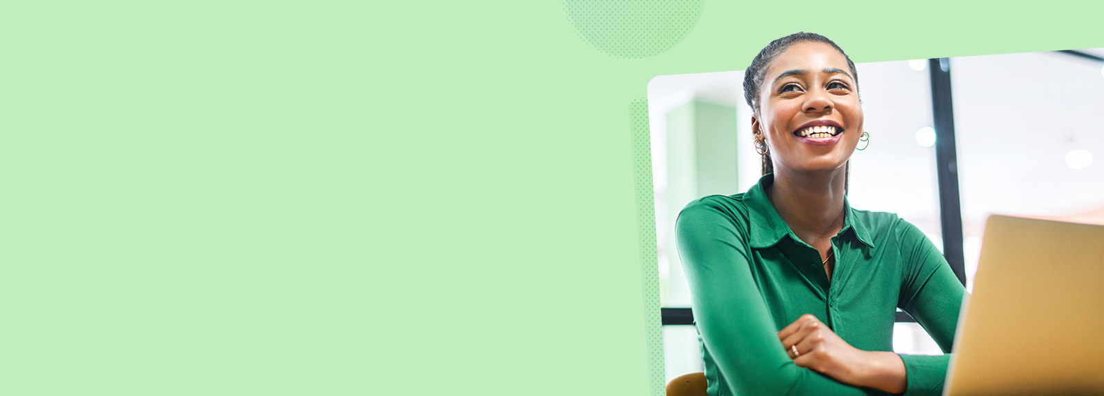 Smiling woman sat down in front of a laptop