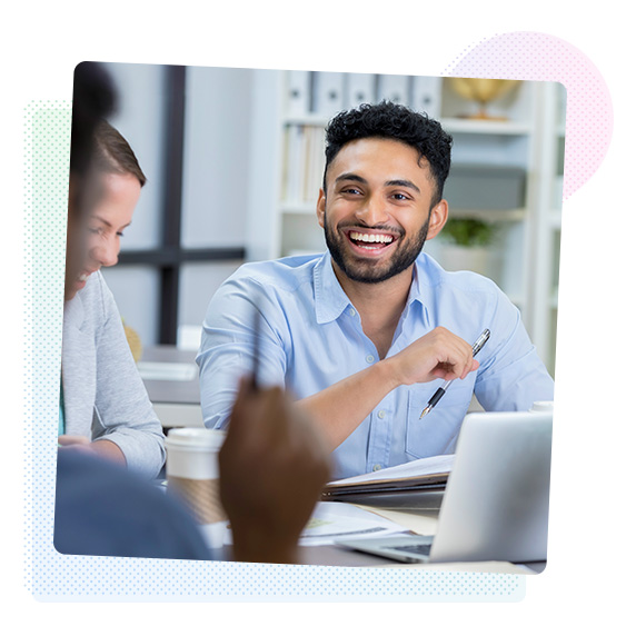 Smiling man sitting at a meeting table