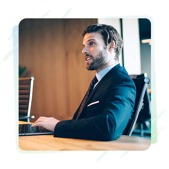 Man in a suit sat in an office chair 
