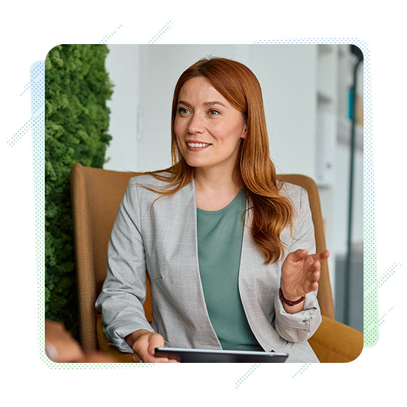 A woman sitting down smiling in an office setting 