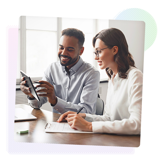A man showing a woman something on a tablet.