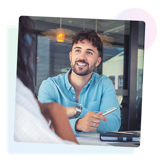 Smiling man holding a pen