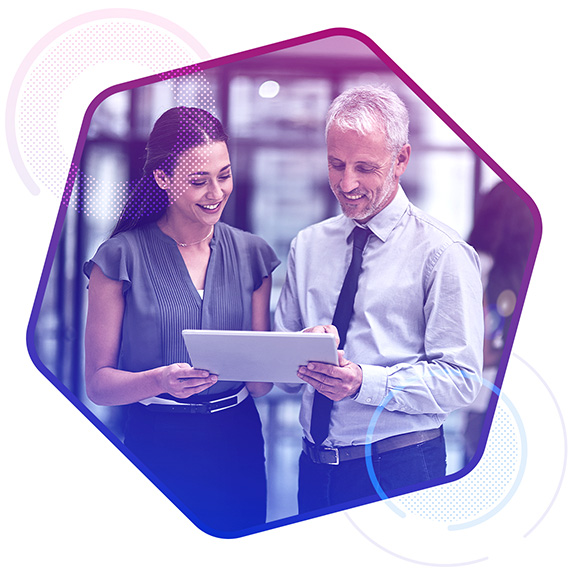 A man and a woman looking at a tablet